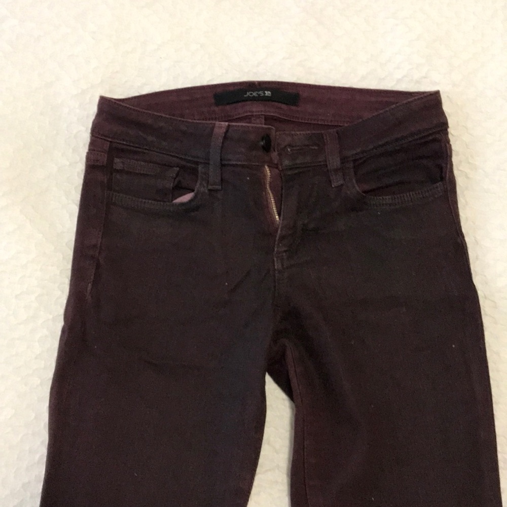 Maroon denim pants.